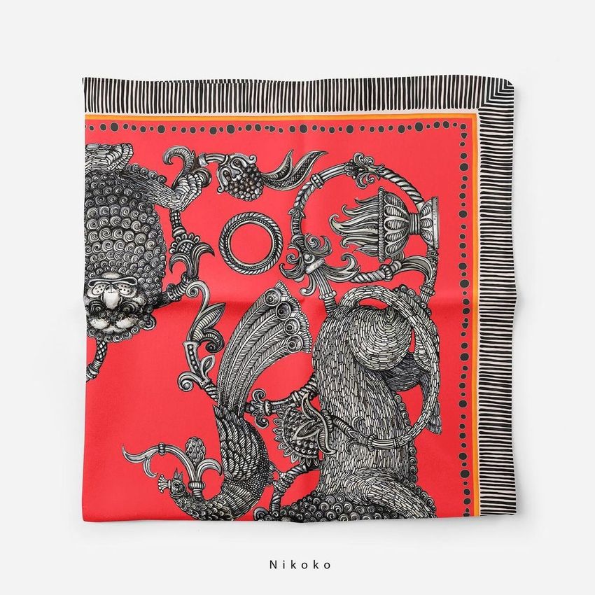 Silk scarf mockup featuring an intricate black and white illustration on a bold red background, laid flat on a white surface.