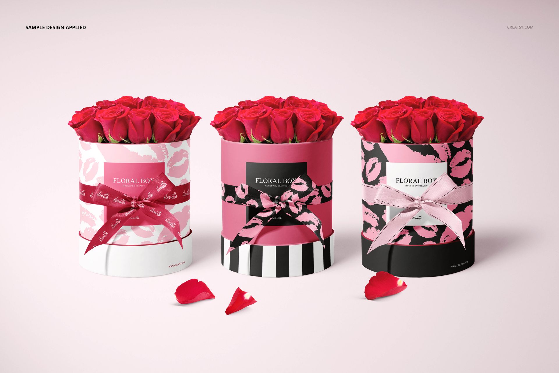 PSD mockup of floral packaging boxes holding red roses, shown in a row with different patterned exteriors and scattered petals.