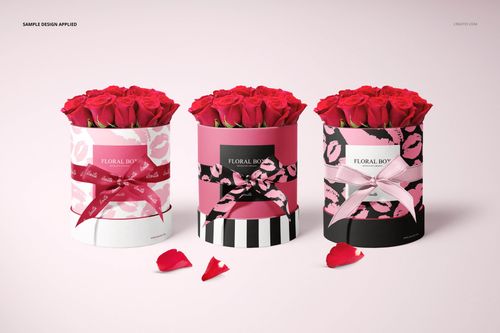 PSD mockup of floral packaging boxes holding red roses, shown in a row with different patterned exteriors and scattered petals.
