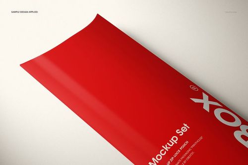 Angled view of a red pillow box mockup with bold white lettering, set against a neutral surface.