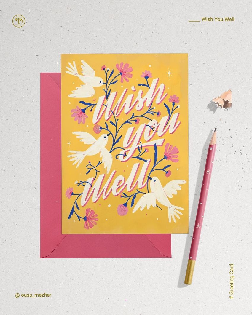 Greeting card mockup featuring a yellow card with white doves and pink flowers, placed on a red envelope with a pink pencil nearby.