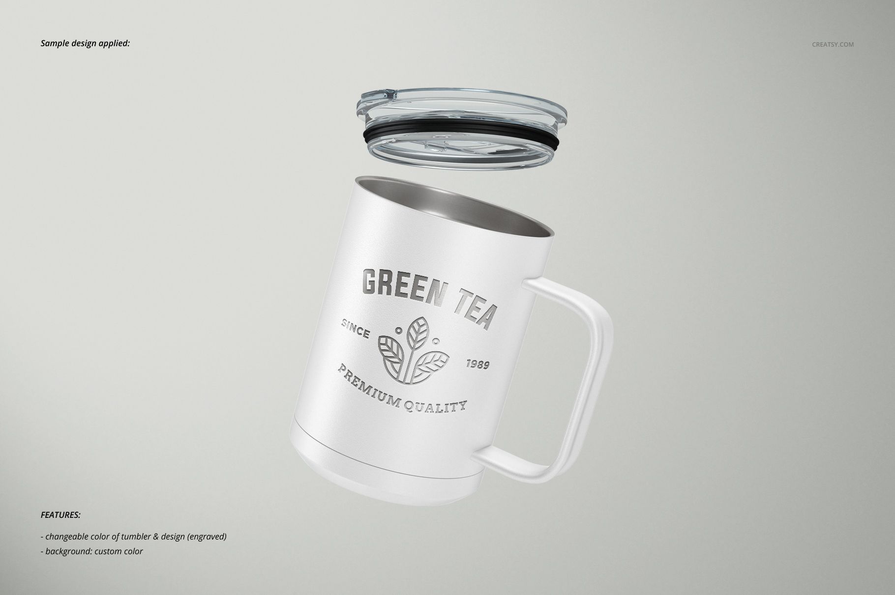 White camp coffee mug with a handle and clear lid, featuring a green tea design, floating on a light background.