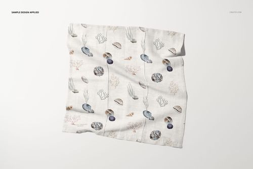 Flat cotton linen napkin mockup showing a neutral background and marine illustrations like shells and plants.