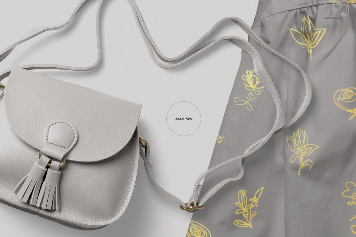 Front view of a light gray baby dress mockup with yellow floral patterns next to a matching gray crossbody bag.