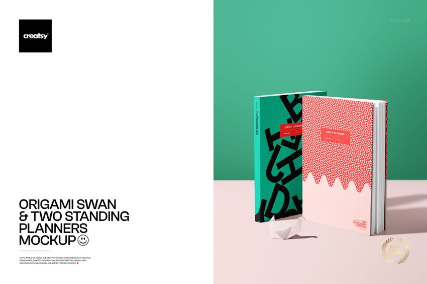 PSD mockup featuring two vertical planners with distinct patterns, accompanied by a paper origami swan on a light table.