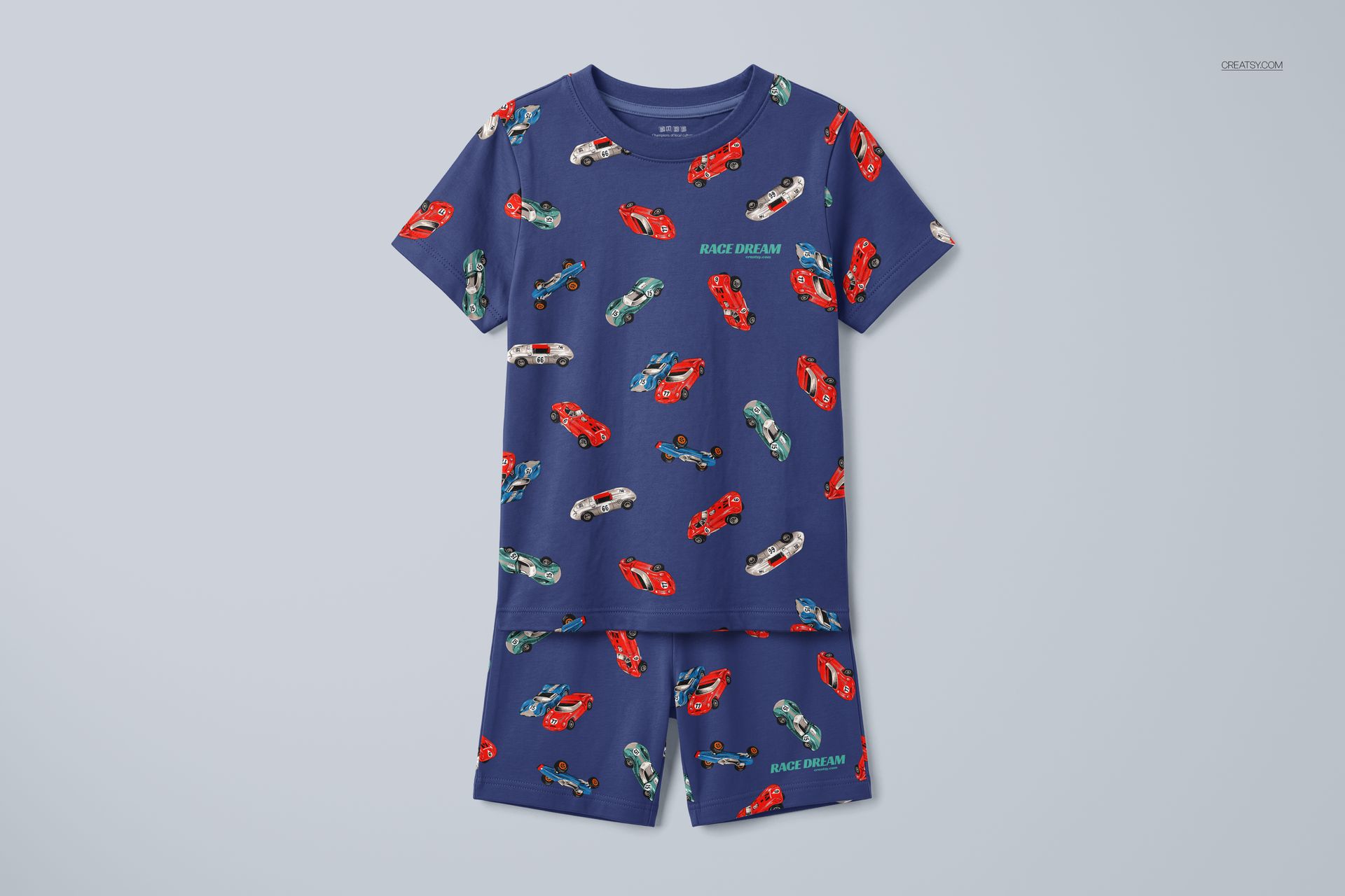 Front view of a blue kids short pyjamas mockup with red, green, and white race cars printed all over the fabric.