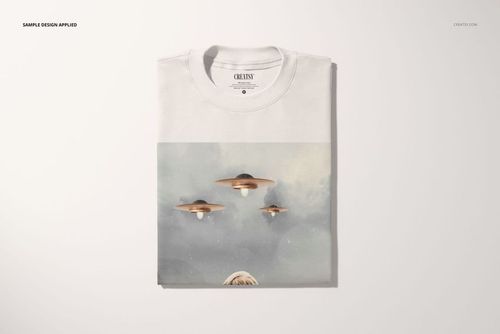 Oversized t-shirt mockup in a folded arrangement, featuring a UFO-themed graphic on a light background, front view.