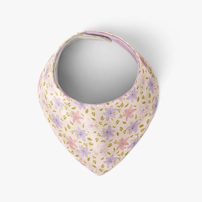 Baby bandana bib mockup featuring a soft fabric bib with a pastel floral pattern in pink and lavender on a white background.