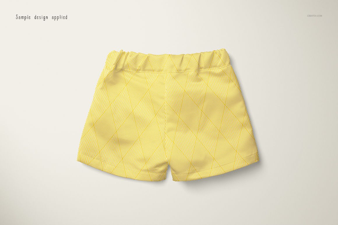 Front view of baby shorts in a PSD mockup, featuring a yellow fabric with a subtle diamond pattern on a light background.