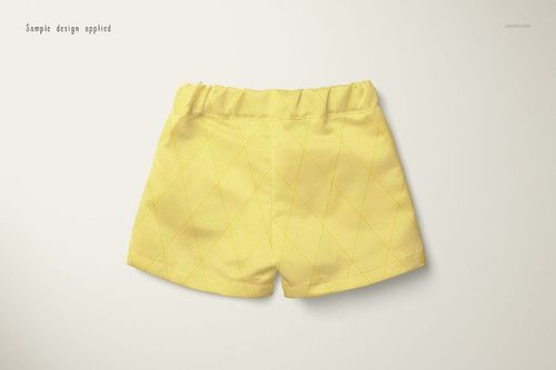 Front view of baby shorts in a PSD mockup, featuring a yellow fabric with a subtle diamond pattern on a light background.