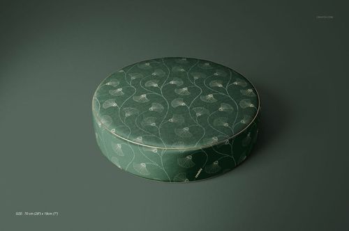 PSD mockup of a circular pouf with a green floral motif, presented at an angle against a green backdrop.