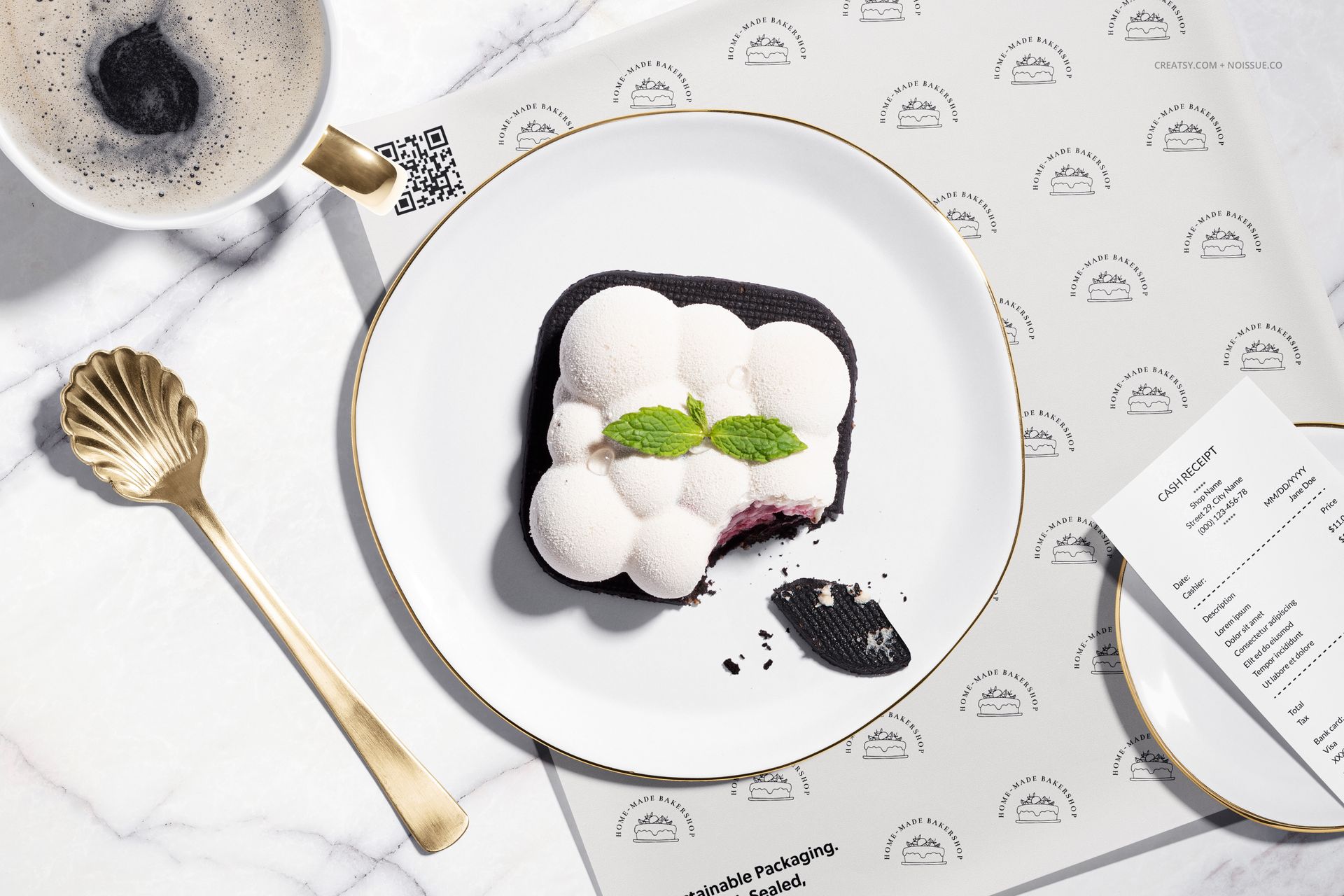 Top view of a modern dessert with mint garnish on a white plate, shown with food safe paper mockup and gold spoon.