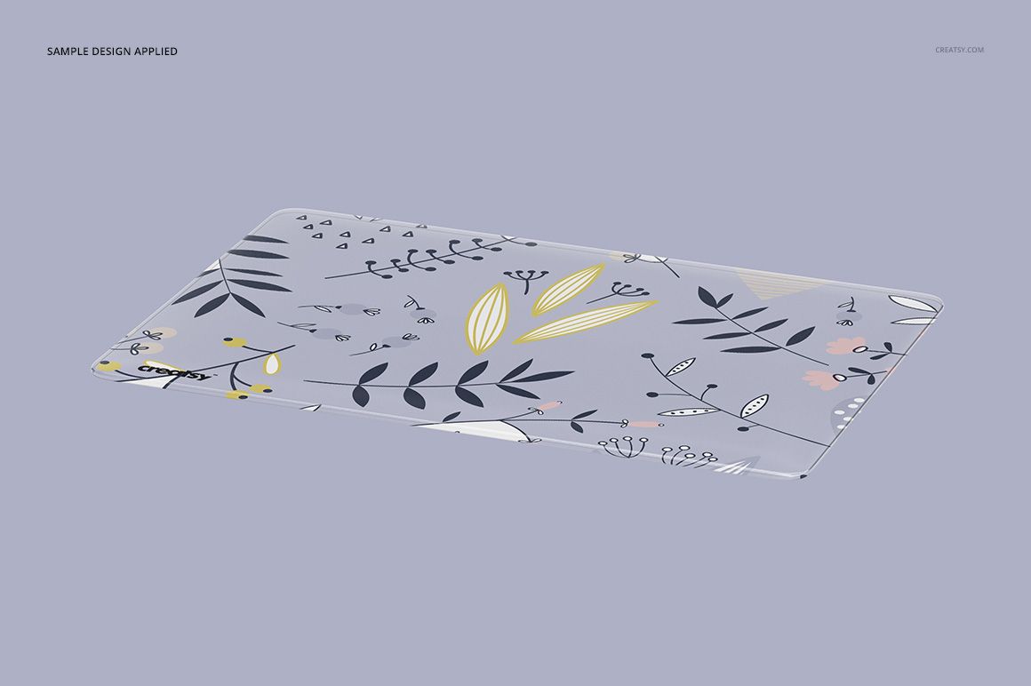 PSD mockup of a clear MacBook cover with illustrated plant elements, positioned diagonally against a soft pastel backdrop.