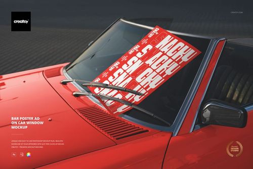 PSD mockup showing a large red and white poster positioned on the front window of a classic red car in daylight.