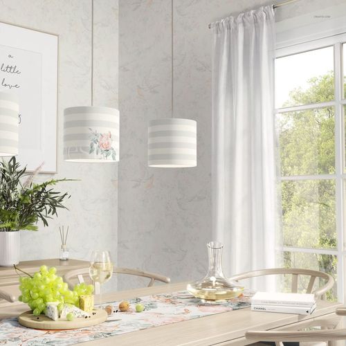 Lamp shade PSD mockup set showing cylindrical shades with subtle patterns, suspended over a table in a sunlit home interior.