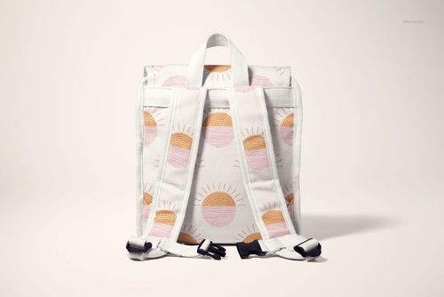 Kids backpack mockup with white fabric and pastel sun pattern, shown from the back with visible straps and buckles.