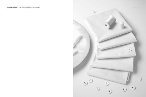 Neatly stacked white fabric squares accompanied by sewing accessories, presented as a PSD mockup scene.