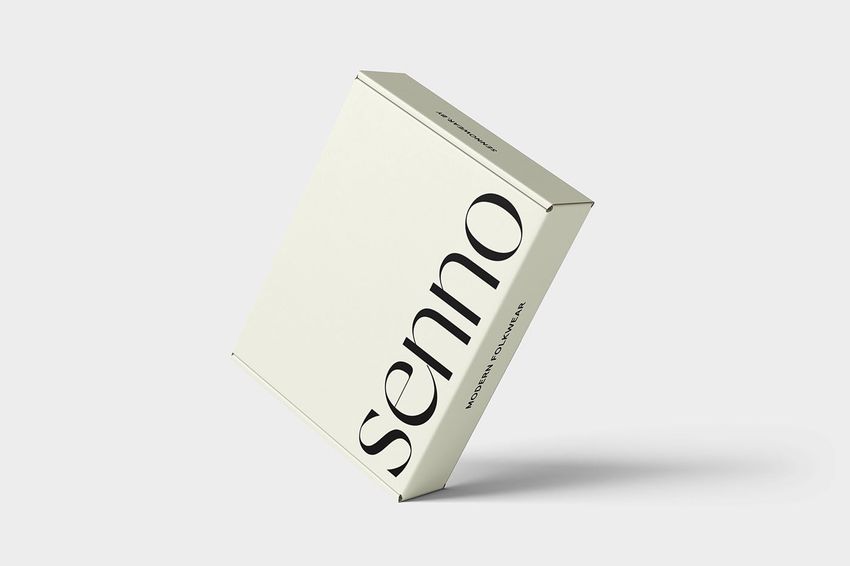 Mailing box mockup featuring a minimal cream-colored box with large black text, displayed at an angle on a light gray background.