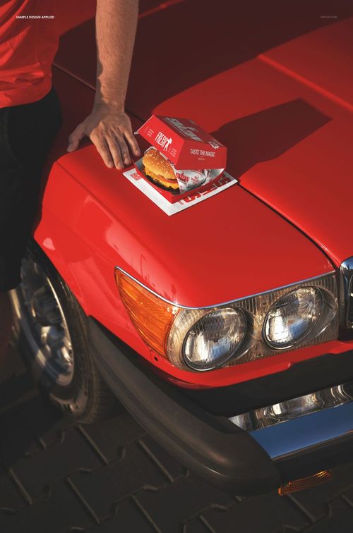 Burger box packaging mockup displayed on the hood of a red car, with a person’s arm resting nearby.