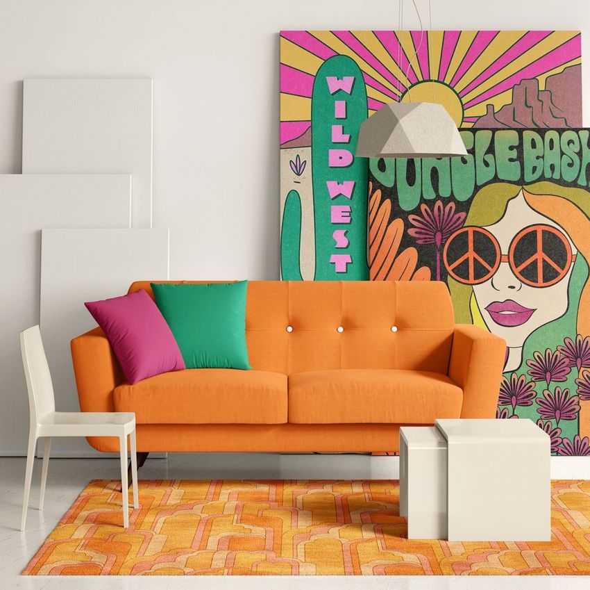 Modern sofa mockup featuring an orange couch with colorful pillows, a white chair, and geometric tables on a patterned rug.