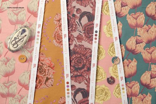 Top view of cotton fabric sample mockup with multiple strips in floral designs and decorative buttons.