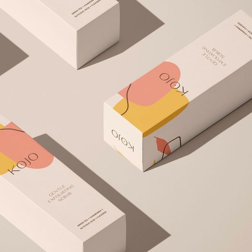 Tall box mockup featuring four rectangular packaging boxes with abstract pastel shapes and minimal text on a beige surface.