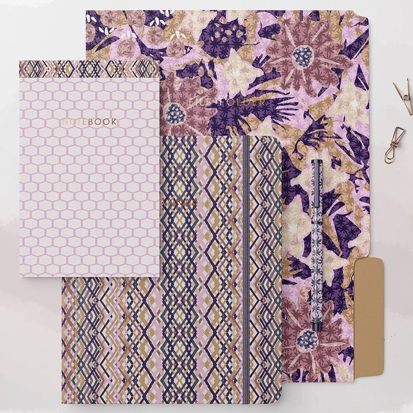 Stationery set mockup featuring notebooks and folders with floral and geometric patterns in pink, beige, and purple tones.