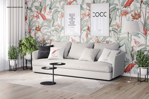 Front view of a stylish interior with a sofa, patterned pillows, and nature-inspired wallpaper in a PSD mockup.