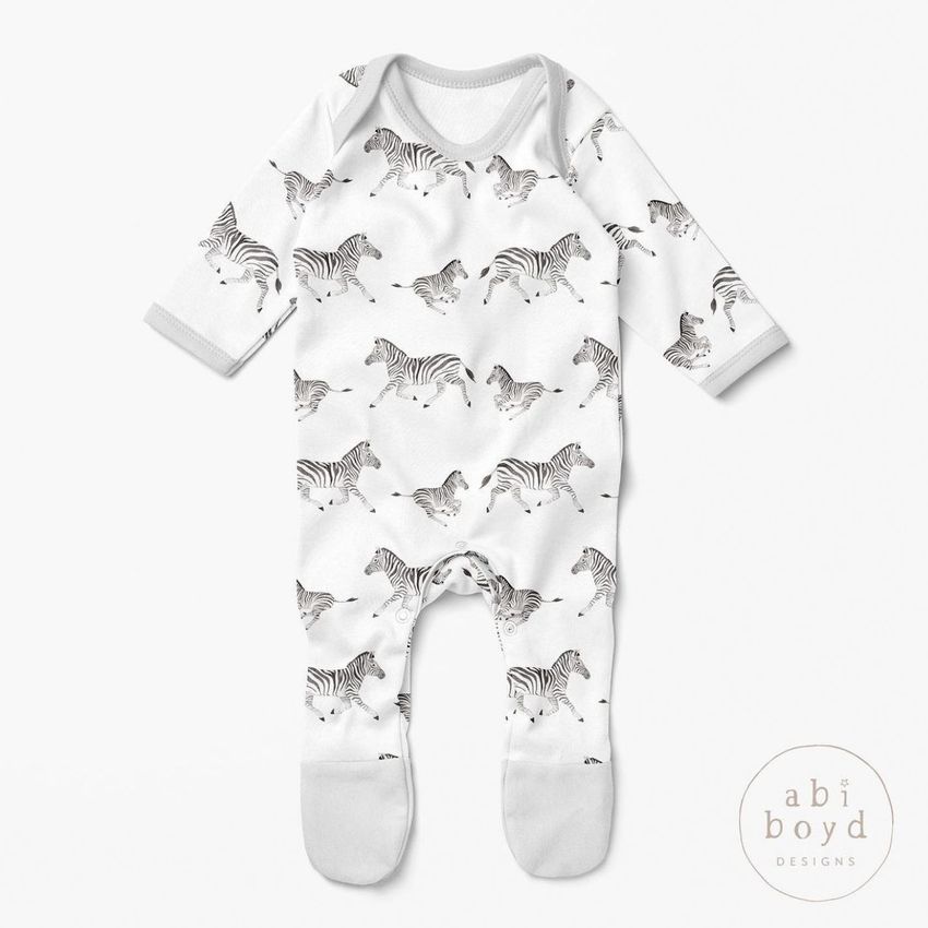 Baby chest rompersuit mockup featuring a white one-piece with an all-over zebra pattern, displayed on a plain light background.