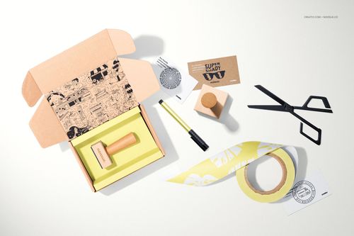 Top view of a wooden stamp mockup set with packaging, stationery items, tape, and printed paper elements.
