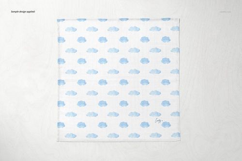 Baby muslin square nappy mockup featuring a repeating blue cloud design, shown from above on a pale background.