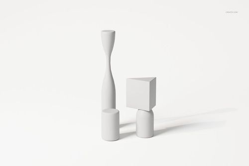 Front view of three abstract cubist style decorative sculptures in matte white, featuring geometric shapes on a plain background.