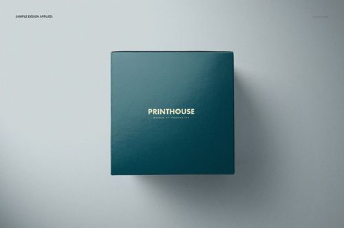 Square gift box mockup featuring a glossy teal surface and centered gold lettering, viewed from above.