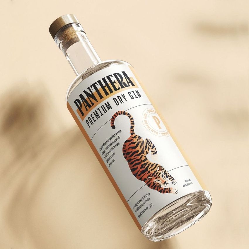 Classic corked glass bottle mockup featuring a clear bottle with a tiger illustration and bold text label, set on a beige background.