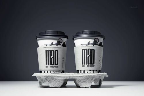 PSD mockup featuring a pair of paper cups with black lids and custom sleeves, displayed in a drink tray under studio lighting.