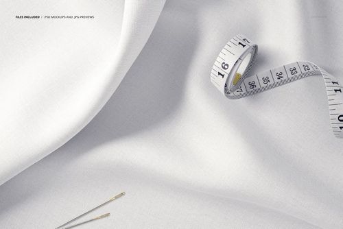 White cotton textile mockup shown in a detailed close-up, featuring a measuring tape and two sewing needles nearby.