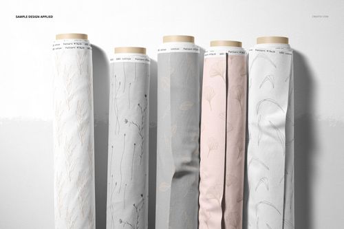 Fabric rolls mockup showing a row of cotton and jersey textiles in muted tones with minimalist plant-inspired designs.