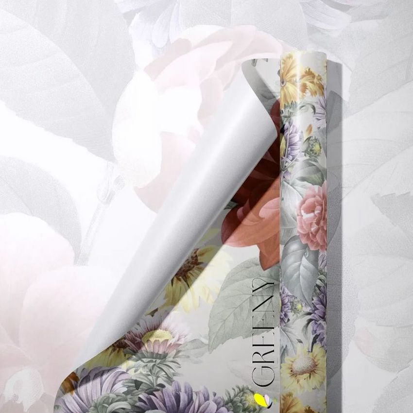 Gift wrapping paper mockup showing a rolled sheet with a floral pattern in soft pastel colors on a light background.