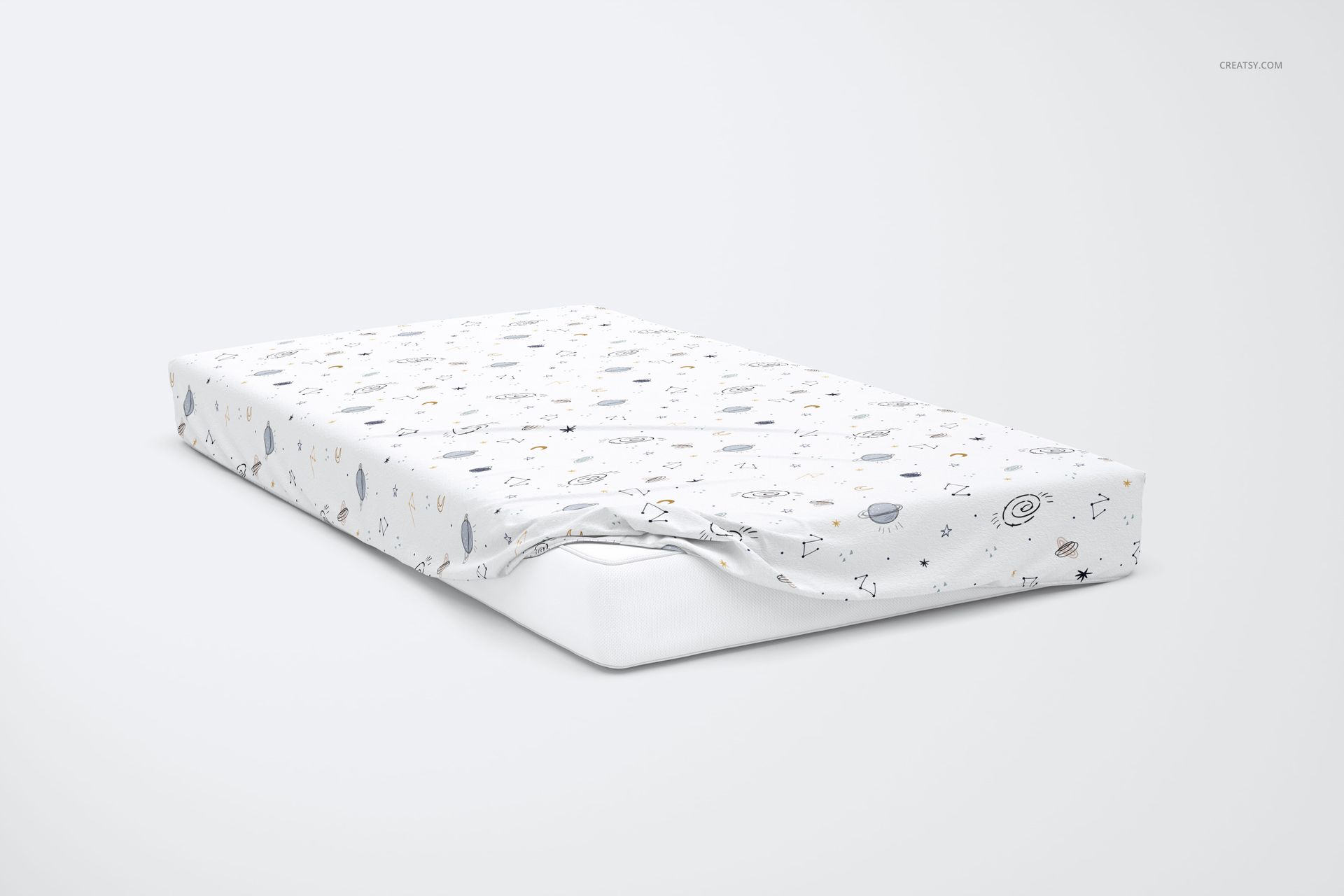PSD mockup of a kids bed sheet with whimsical star and planet designs, displayed on a mattress against a light background.