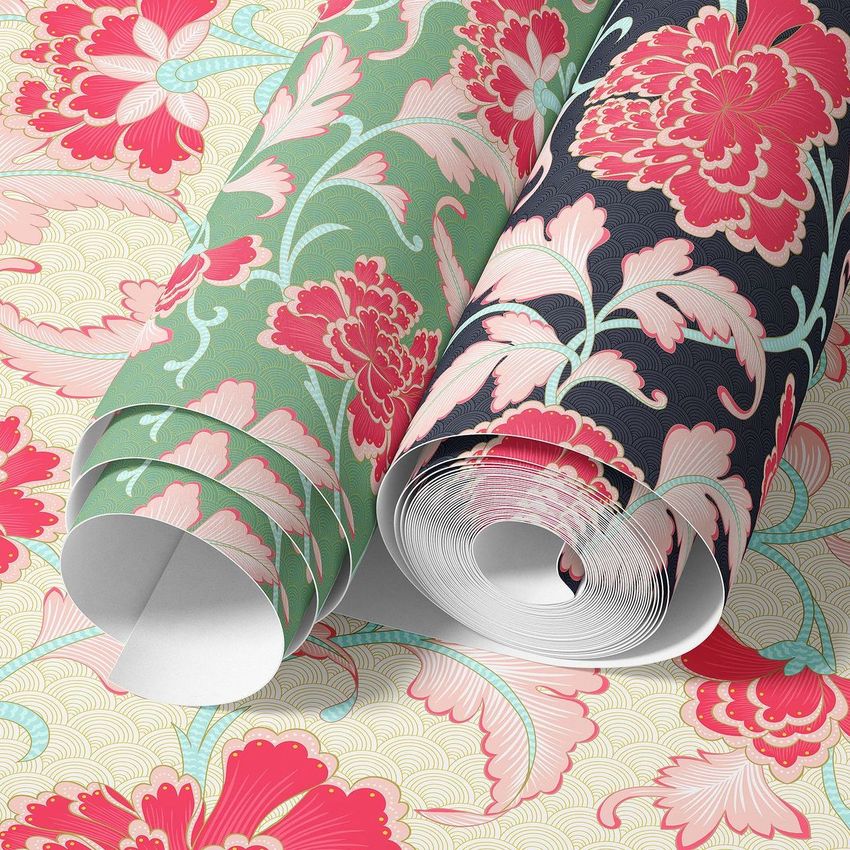 Paper wallpaper mockup showing two rolled sheets with floral patterns in pink, green, and dark blue on a matching background.