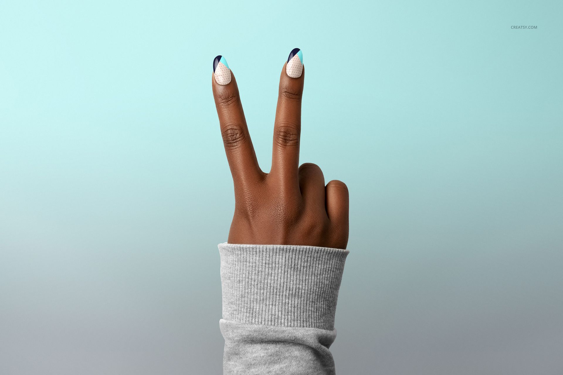 PSD mockup of a hand displaying two fingers, nails decorated with white and blue polish, set on a pale blue gradient background.