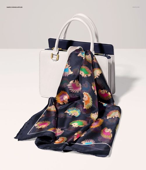 Habotai silk scarf with multicolored animal motifs displayed over a white handbag in a PSD mockup scene.