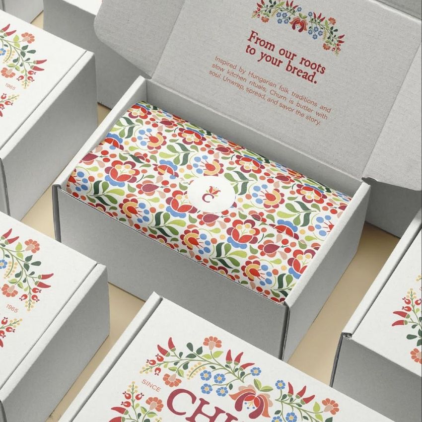 Mailing box mockup featuring an open box with colorful Hungarian folk-inspired floral pattern paper inside, surrounded by closed boxes.