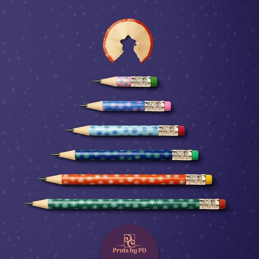 Pencil Christmas tree mockup showing six colored pencils arranged in a tree shape on a purple background with snowflake patterns.
