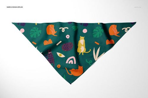Triangular pet bandana mockup with colorful cat and abstract patterns on a dark green background, front view.