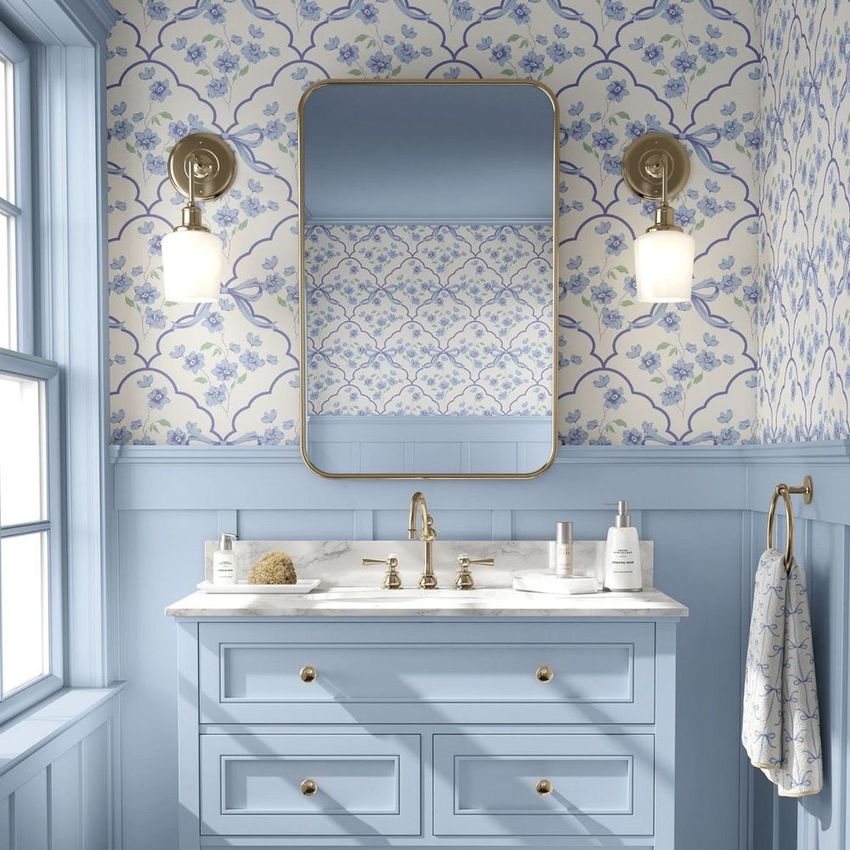 Bathroom mockup featuring a blue vanity with marble countertop, brass fixtures, and floral wallpaper in soft blue tones.