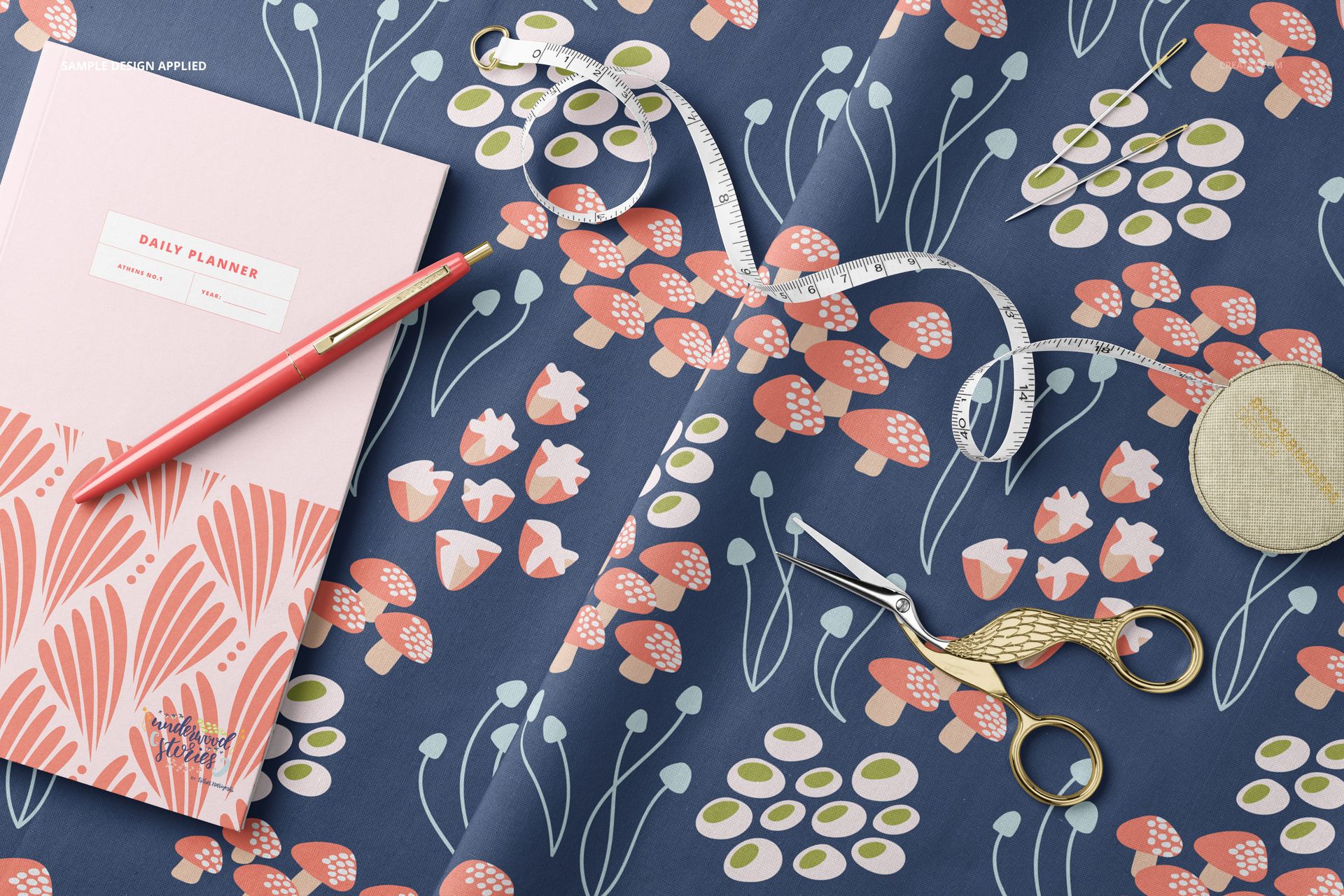 Top view of cotton fabric mockup featuring a colorful floral design, with sewing accessories and a daily planner nearby.