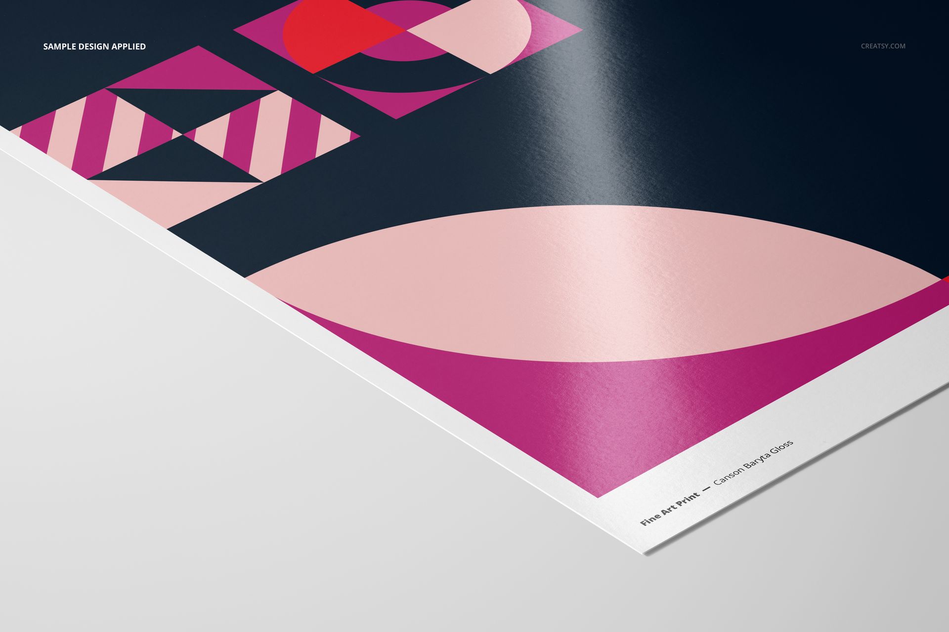 Glossy fine art print mockup featuring geometric patterns in pink, red, and black, shown from a corner angle.