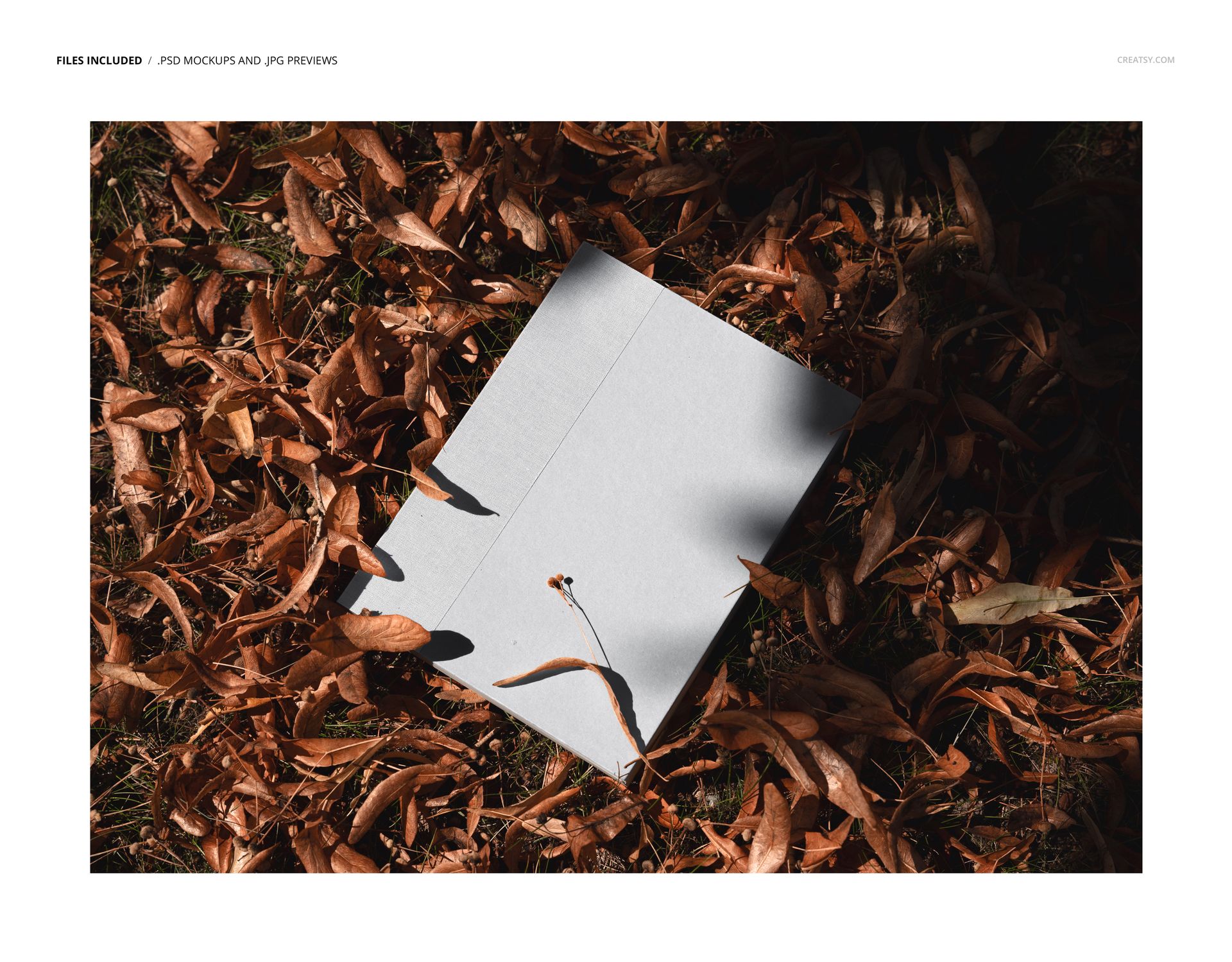 PSD mockup featuring a blank planner resting on dried leaves outdoors, viewed from a top-down perspective.