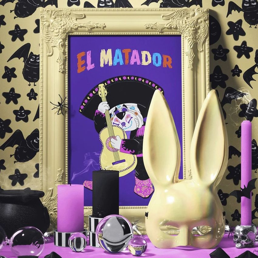 Halloween picture frame mockup featuring a colorful art print of a skeleton musician on a purple background, surrounded by themed props.